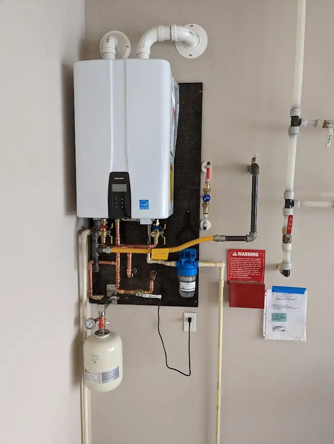 Professional plumber installing copper piping in a Garrett home